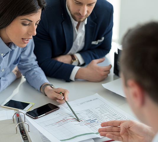 Real estate agent reviewing an offer contract with clients